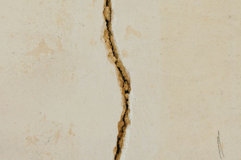 Hairline crack in a white concrete wall